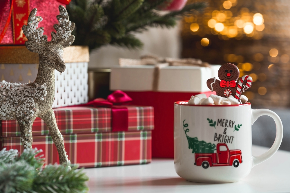 a ceramic mug with some Christmas gifts